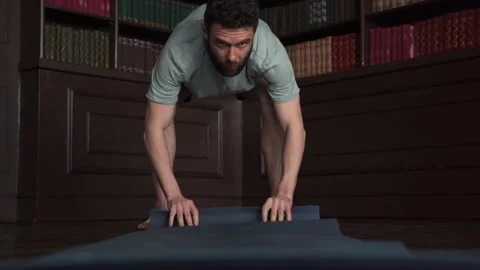 Close Up of Mans Hands Roll Out Yoga Mat For Fitness. Man Rolling Blue Yoga Mat. Stock Footage 152567431