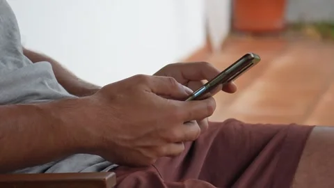 Close up of man's hands scrolling on mobile phone Stock Footage 340994523