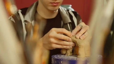 Close-up of a man's hands sculpting a clay figurine. Stock Footage 246862061