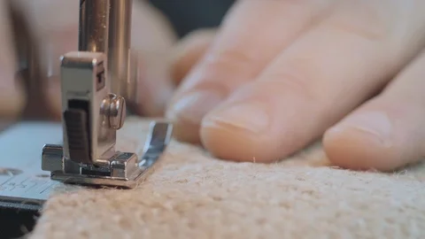 Close-Up Man's Hands Sew With A Sewing Burlap Fabric On A Sewing Machine. 4k Stock Footage 121536240