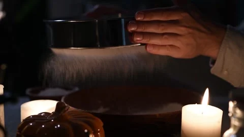 Close-up of man's hands sifting flour to remove husk in low light. Vidéo 309259299