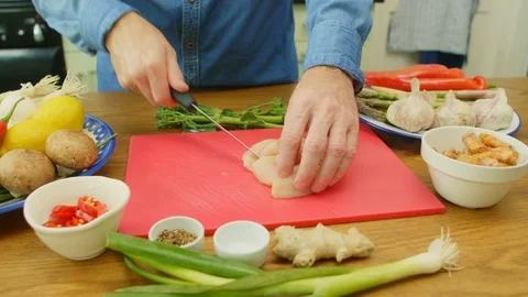 Close-up Of Man's Hands Slicing Raw Chicken On Chopping Board Stock Footage 86073101