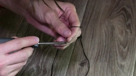 Close-up of a man's hands soldering two computer wires. Video stock 346882147