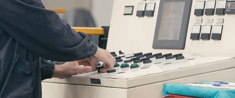 Close-up of a man`s hands on start up button on the control panel in a factory Stock Footage 90277734