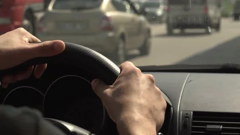 Close-up of a man's hands on the steering wheel driving a car Stock Footage 158581610