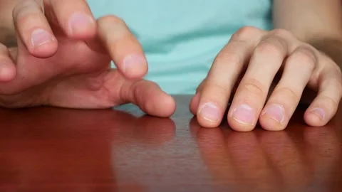 Close up of mans hands on a table drumming on it with the fingers nervously Stock Footage 140817324