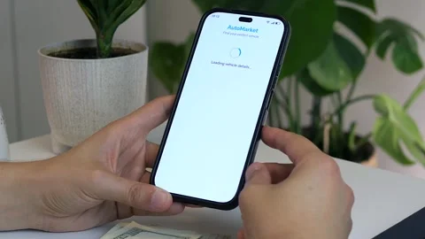Close-up of a mans hands at a table with money and a phone in his hands, on the Stock Footage 315290841