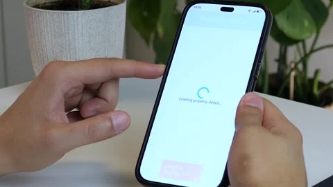 Close-up of a mans hands at a table with a phone in his hand, on the screen of Stock Footage 315290820