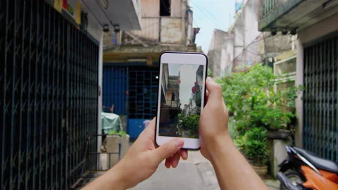 Close up of mans hands taking photo or video of Bangkok alley way street corner Stock Footage 201094439