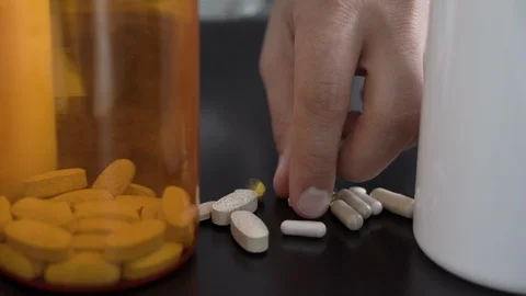 Close-up of a man's hands taking pills. Stock Footage 110797878