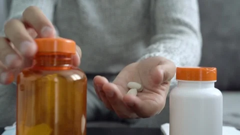 Close-up of a man's hands taking pills. Stock Footage 110805707