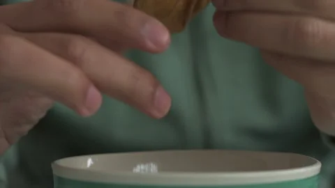 Close up of a man's hands turning a cape gooseberry Stock Footage 134576823