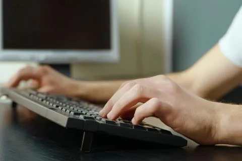 Close up man's hands typing on computer keyboard Foto stock