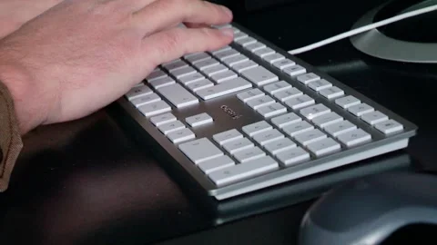 Close-Up: Man's Hands Typing on Keyboard in Home Office - 4K Stock Footage 257975183