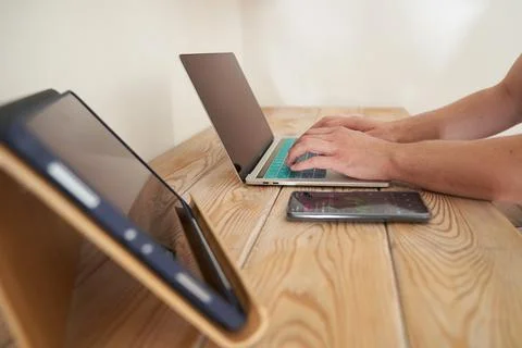 Close-up of a man's hands typing on a keyboard, looking for information. A Stock Photos