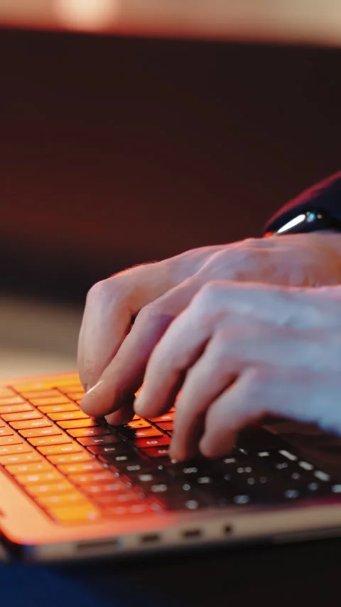 Close-up of a mans hands typing on a laptop night on the street. blurred Stock Footage 253975299
