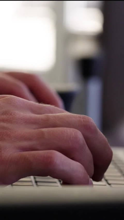 Close up man's hands typing on laptop computer vertical video Video stock 284811618