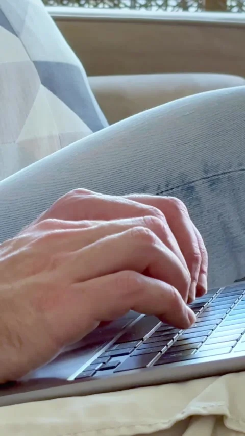 Close up of a man's hands typing on a laptop computer keyboard, sending Stock Footage 347191213