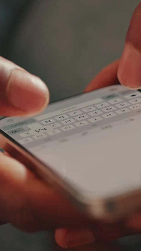 Close-Up: Man's Hands Typing on Smartphone Stock Footage 332684024