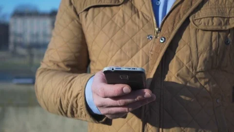 Close up of man's hands typing sms on smartphone app, man walks up, go away Vídeo Stock 73066475