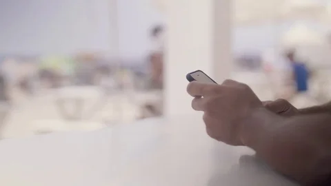 Close-up of a man's hands use a smartphone, a man holds a mobile phone, writes Stock Footage 73796830