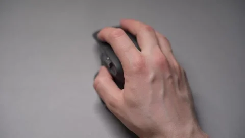 Close up man's hands use a wireless computer mouse. Click on the gray wireless Stock Footage 307703286