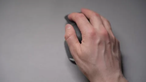Close up man's hands use a wireless computer mouse. Click on the gray wireless Stock Footage 307703630