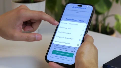 Close-up of a mans hands using a healthcare app on his phone to schedule a Stock Footage 316129209