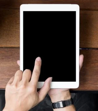 Close up of mans hands using tablet on counter Stock Photos