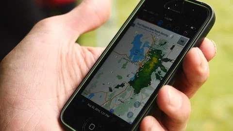 Close up of man's hands using weather app on cell phone outside. Stock Footage 102584466