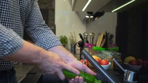Close up on man's hands washing courgette. 库存影片 70574718