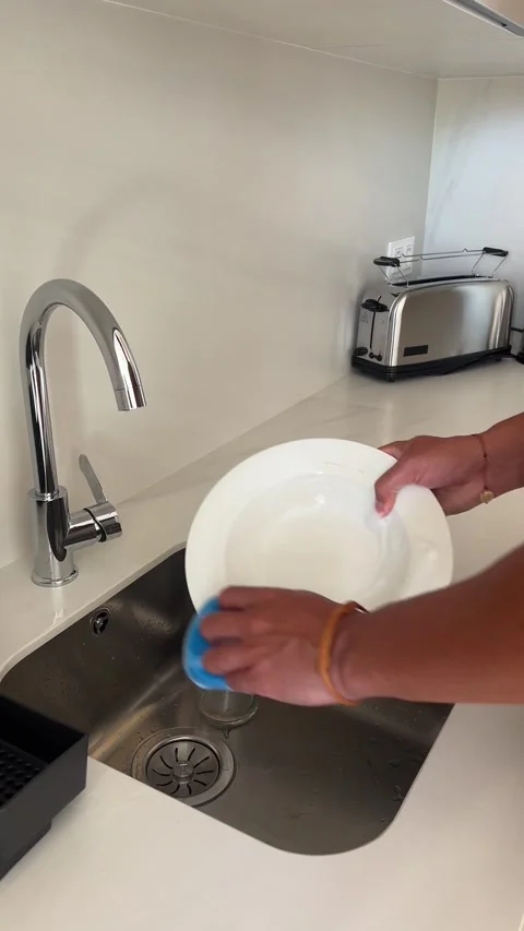 Close-up of man's hands washing a dish in a sink. Stock Footage 300353086