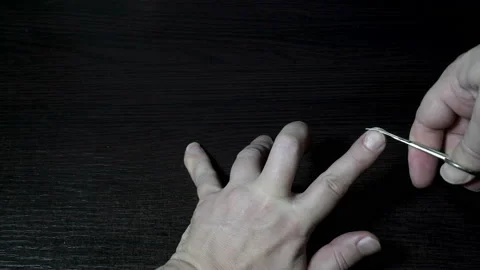 Close-up of man's hands, which cut their long nails on the hand metal scissors 스톡 동영상 143142983