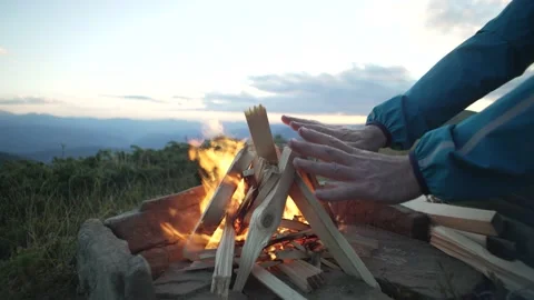 Close-up of a man's hands, which he warms near a campfire in the mountains. Stock Footage 214326154