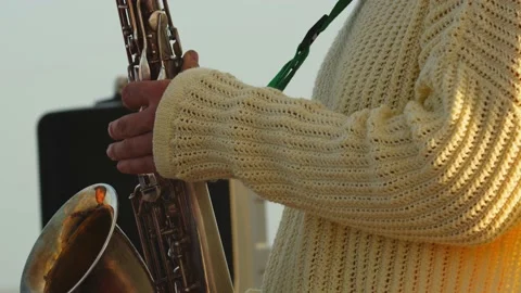 Close up of the mans hands while he is playing saxophone, musical performance 4k Stock Footage 143246428