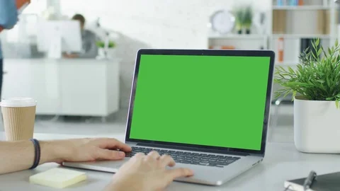Close-up of a Man's Hands Working on Green Screen on a Laptop. Stock Footage 70853258