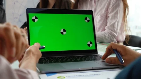 Close-up of a Man's Hands Working on Green Screen on a Laptop.In the background Stock Footage 113814241