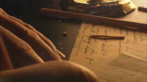 Close-Up of man's hands writing at a Tabletop by candlelight Video stock 91043553