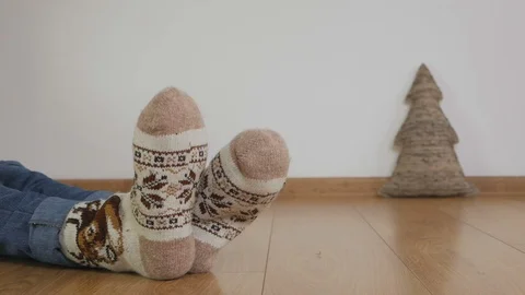 Close-up of a man's legs dressed in warm knitted wool socks with an ornament Stock Footage 102591471