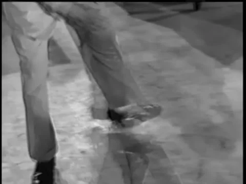 Close-up of man's legs as he tap dances across floor, 1950s Stock Footage 260258389
