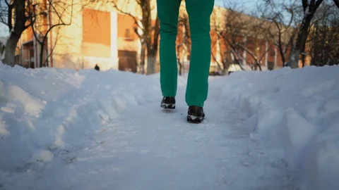 Close Up On Man's Legs As He Walking On A Snowy Alley In Park Stock Footage 126237536