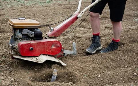 Close-up of a man's legs with the tractor Stock Photos