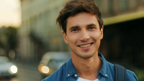 Close up of man's profile on sunny day outside. Portrait of a young smiling boy 動画素材 80799516