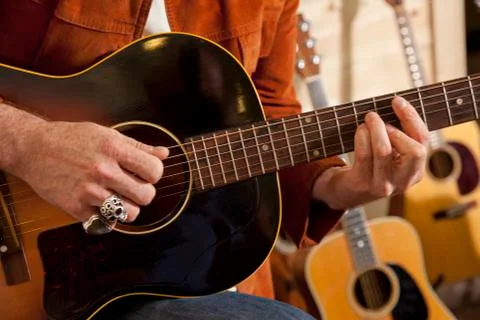 Close-up of man's torso practicing with guitar Stock Photos