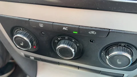 Close-up of manual climate control knobs and air conditioning buttons on a car Stock-Footage 337113403