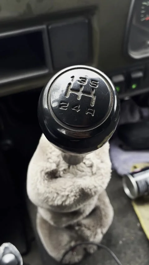 Close-up of a manual transmission gear shift knob with numbered positions inside Stock Footage 339650047