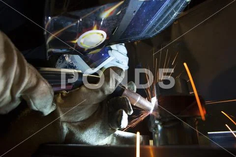 Close-up of manual worker using welding torch at workshop Stock Photos