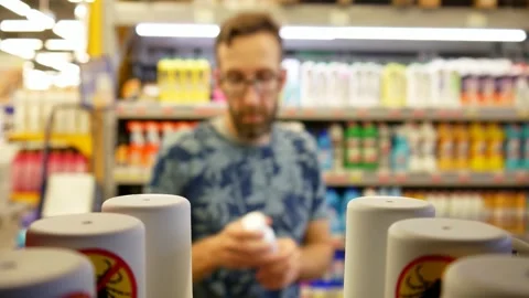 Close-up of many anti mite sprays in a store and a male buyer chooses one Stock Footage 247766688