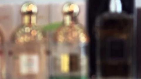 Close-up of many bottles with expensive perfume is out of focus Stock Footage 82498754