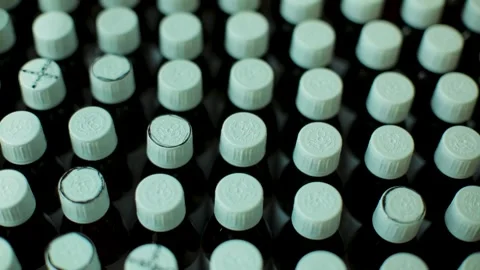 Close-up of many bottles with light blue caps arranged in rows and columns Stock Footage 286422467